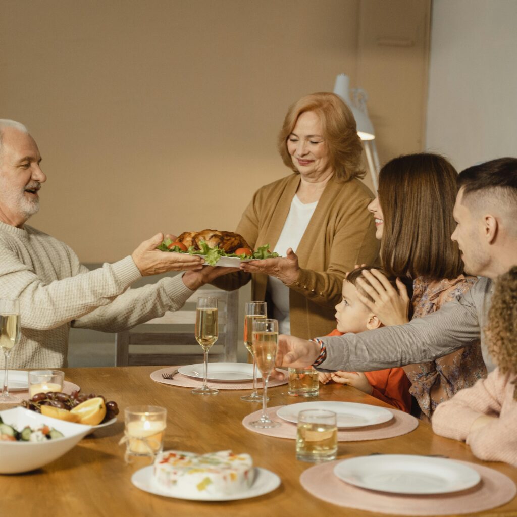 A family gathers around the table, sharing a Thanksgiving meal filled with love and heartfelt messages of gratitude.